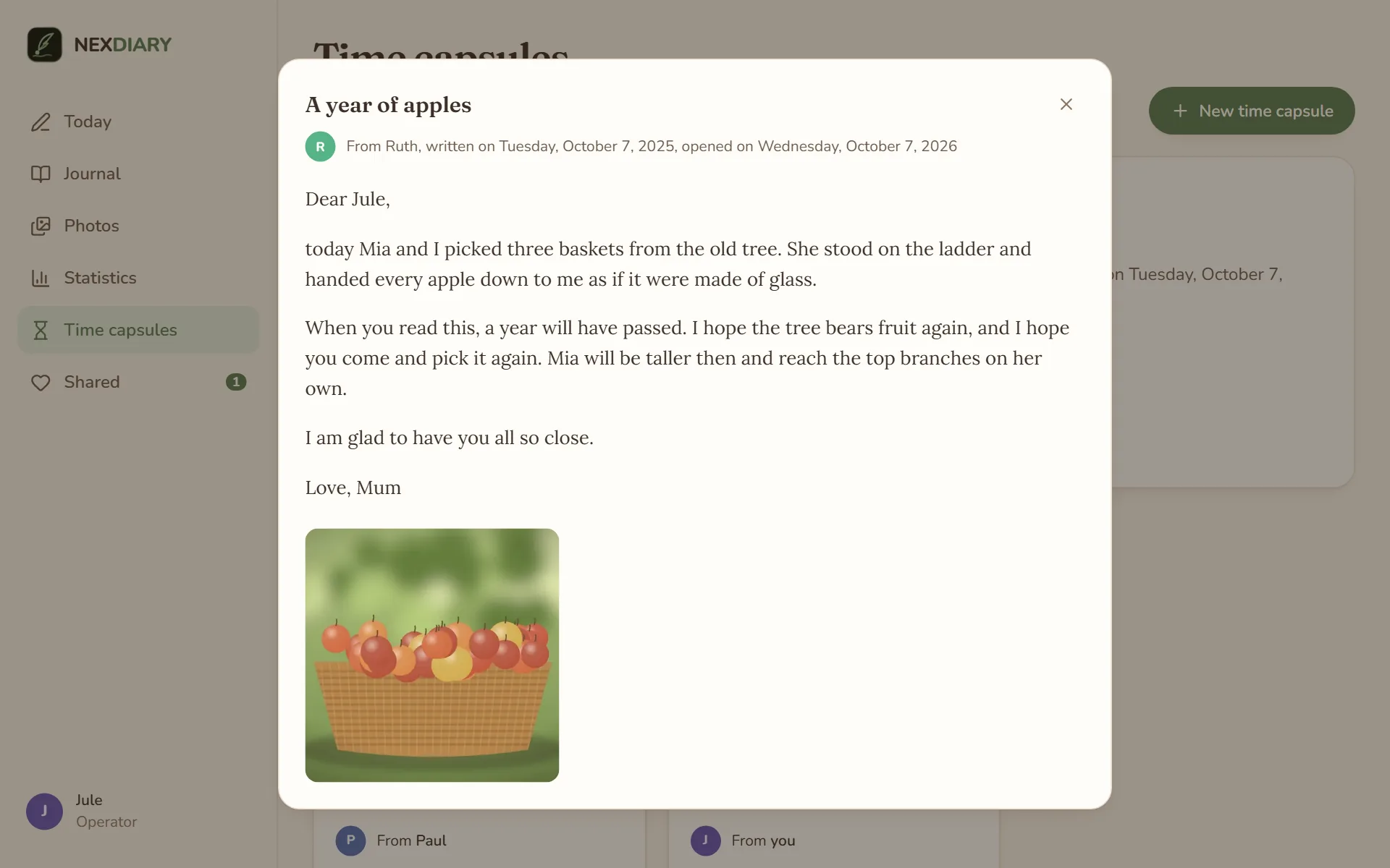 An opened letter “A year of apples” from Ruth, written a year ago, with the letter to Jule and a photo of a basket full of apples